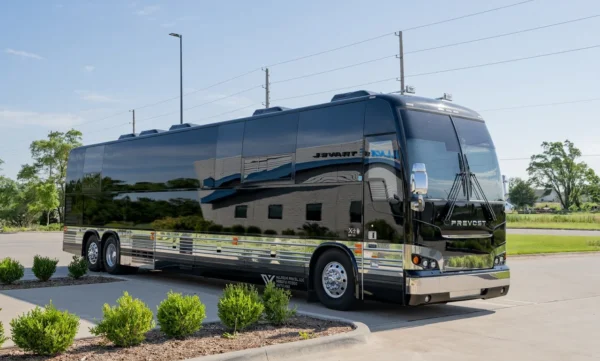 Cash Prevost X3 entertainer coach in gloss black with polished chrome trim, front passenger-side three-quarter view in Wichita